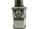 a white and green vase with flowers on it