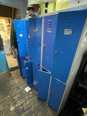 several blue lockers are lined up in a row in a room