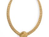 an image of a gold necklace with a knot on it