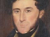 portrait of a man in a black suit and bow tie