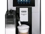 the coffee machine has a cup of coffee in front of it