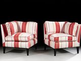 pair of red and white striped chairs against a black background