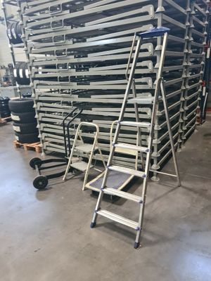 a group of ladders stacked on top of each other in a warehouse