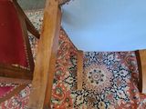 a cat that is sitting on the floor next to a chair