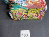 a box of pokemon cards on a table with a price tag