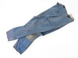 pair of blue jeans with red stitching on them on a white surface