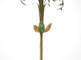 a lamp that is on a stand with a plant on it