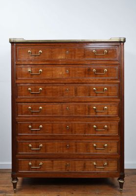 an antique mahogany chest of drawers with brass pulls