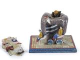 a figurine of an elephant and a figurine of a man