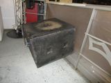 a black box sitting on the floor next to a ladder