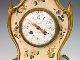 a clock that has been painted with flowers on it
