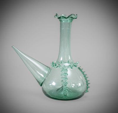 a green glass vase with a decorative design on it