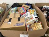 a cardboard box filled with games and other items