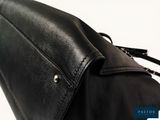 the back of a black leather purse with a zipper on it