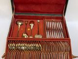 a red case with silverware in it on a white surface
