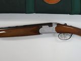a shotgun with a case and a rifle on a table