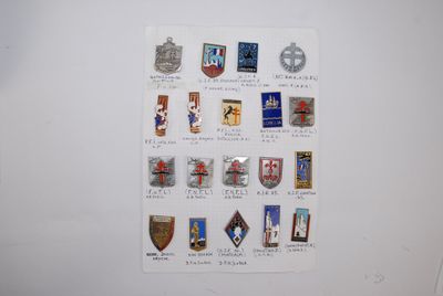 a picture of a wall with a bunch of badges on it