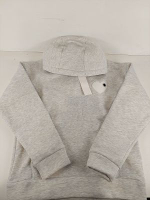 a close up of a grey hoodie with a white tag on it