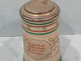 a beer mug with a lid sitting on a table