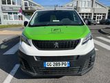 a green and white van parked in a parking lot