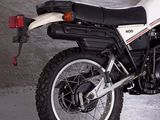 a white and black motorcycle parked in a garage