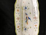 a plate with a bird on it on a black background