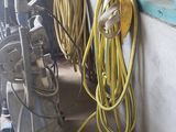 yellow hoses are attached to a wall in a garage