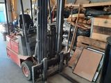 a forklift truck that is parked in a warehouse