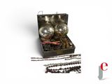 three ornaments in a box on a white surface