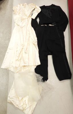 two dresses and a suit on the floor next to each other