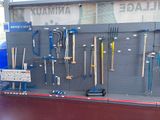 many tools hanging on the wall in the store