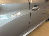 a silver car that has a sticker on the door