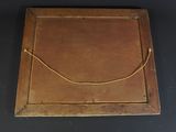 an old wooden picture frame with a rope hanging from it