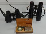 a small wooden box with a watch and a pair of binoculars