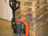 a stack of pallets with a fork and a fork lifter