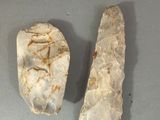 two pieces of stone on a table next to each other