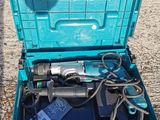 an open tool box sitting on the ground with tools in it