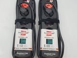 pair of two black and white power cords connected to a power strip