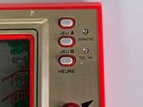 a close up of a red and silver electronic device