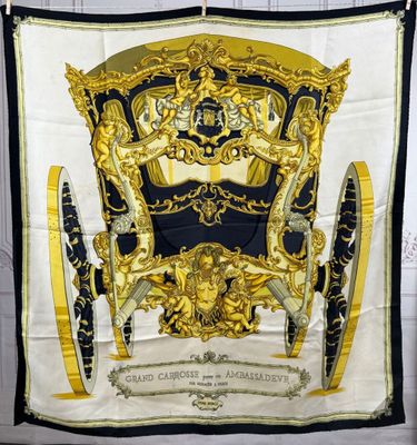 an image of a black and gold scarf hanging on a wall