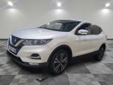 une Nissan QX-V blanche garée sur un sol à damier