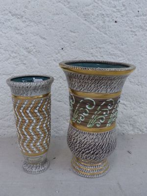 deux vases posés l'un à côté de l'autre sur une table