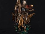 a statue of a man on a horse holding a flag