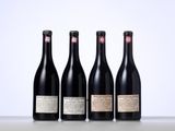 three bottles of wine are lined up on a table