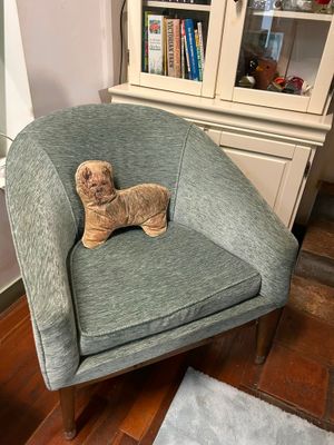 a teddy bear that is sitting in a chair