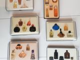 many bottles of perfume on display in a display case