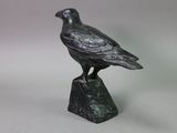 statue of a bird on a rock on a white background