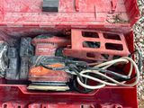 a red tool box with tools in it on the ground