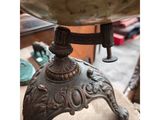 an antique brass plate on a stand with a wooden base