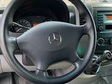 a steering wheel and dashboard of a car in a parking lot
